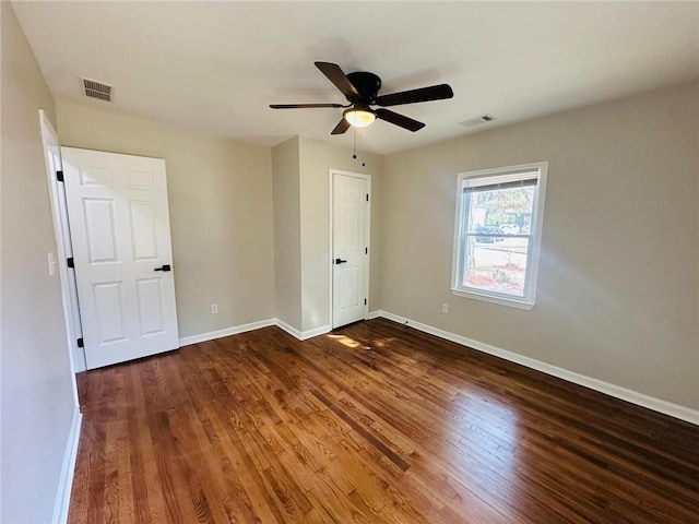 unfurnished bedroom with baseboards, visible vents, and wood finished floors