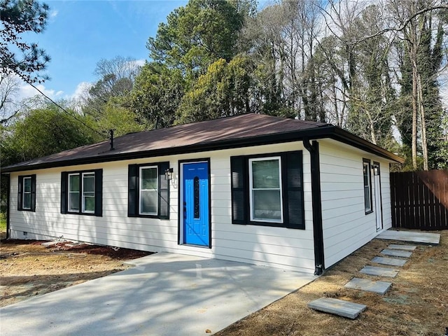 single story home featuring crawl space and fence