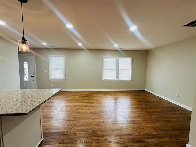 interior space with baseboards, dark wood finished floors, and recessed lighting