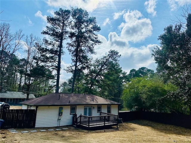 back of property featuring fence and a wooden deck