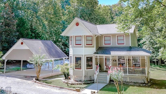 view of front of home with a porch and a carport