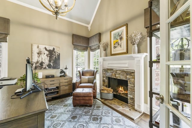 living area featuring a chandelier, wood finished floors, crown molding, a fireplace, and high vaulted ceiling