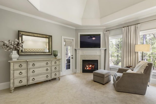 living room featuring ornamental molding, vaulted ceiling, a glass covered fireplace, and light colored carpet