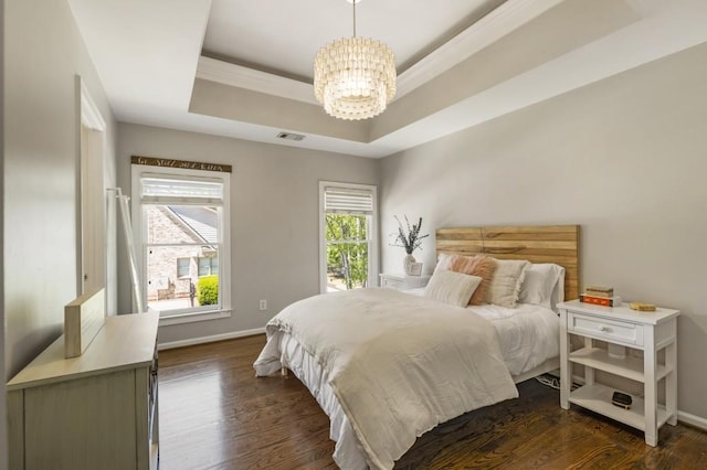 bedroom featuring dark wood-style floors, a raised ceiling, visible vents, baseboards, and a chandelier