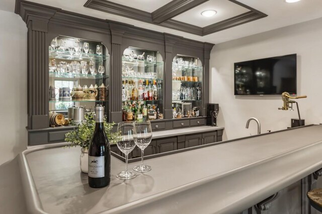 bar with indoor wet bar, recessed lighting, coffered ceiling, and crown molding