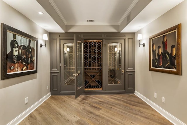 wine area featuring baseboards, wood finished floors, and visible vents