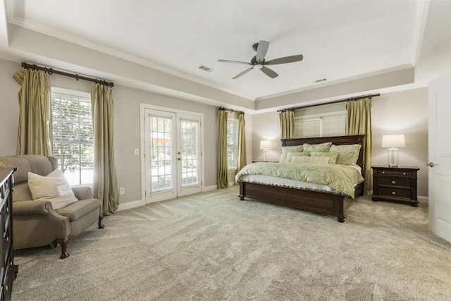 bedroom featuring a raised ceiling, visible vents, crown molding, and access to outside