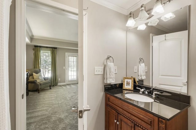 bathroom featuring baseboards, vanity, and ornamental molding