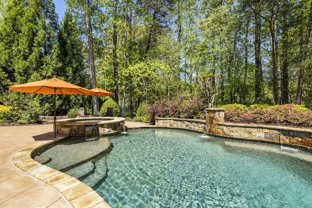view of pool featuring a pool with connected hot tub and a patio