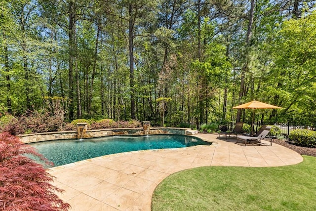 outdoor pool featuring fence, a yard, and a patio
