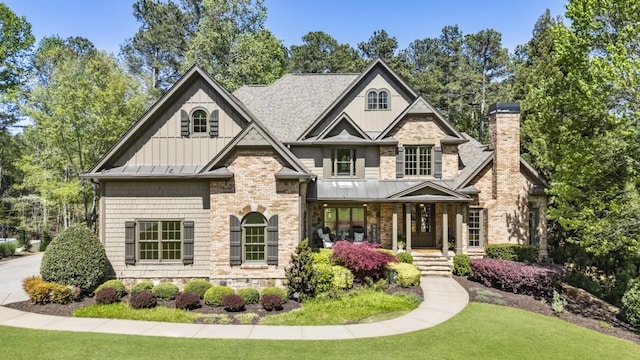craftsman inspired home with a porch, a standing seam roof, and metal roof