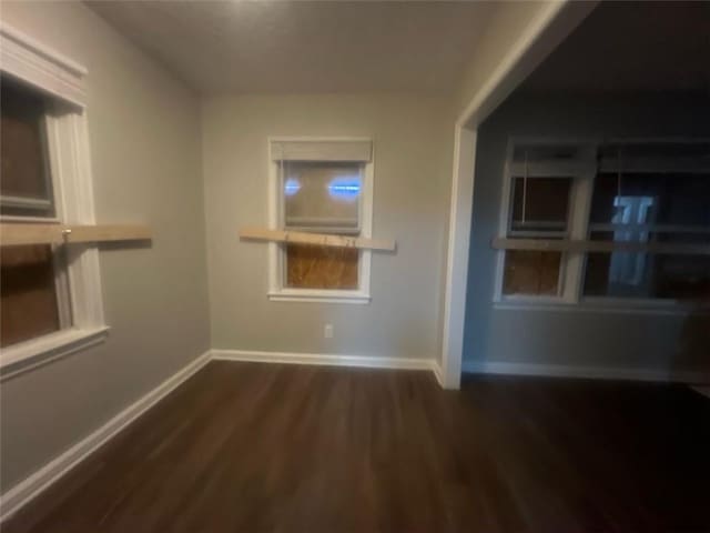 empty room with dark wood-type flooring