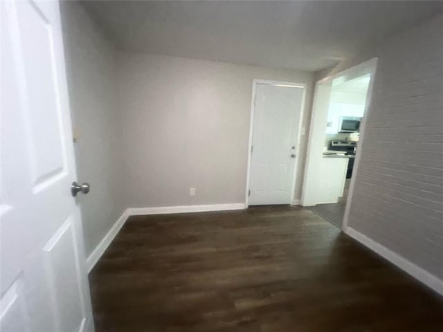 hallway with dark hardwood / wood-style flooring