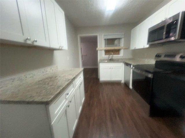 kitchen featuring white cabinets, light stone counters, black / electric stove, and stainless steel dishwasher