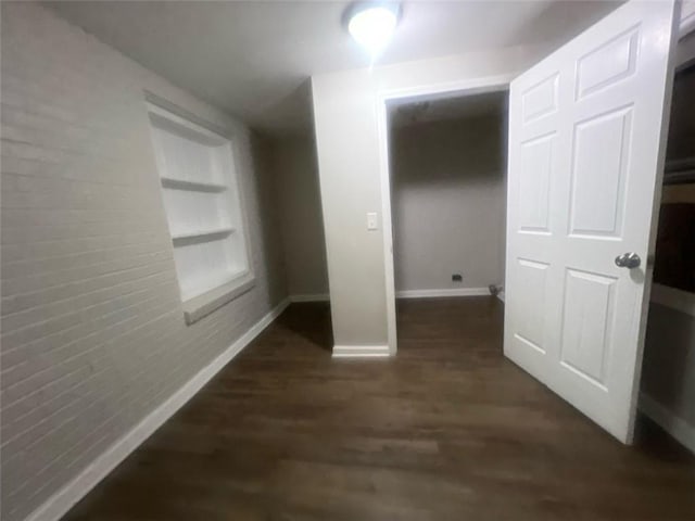 hall with dark hardwood / wood-style floors and built in features