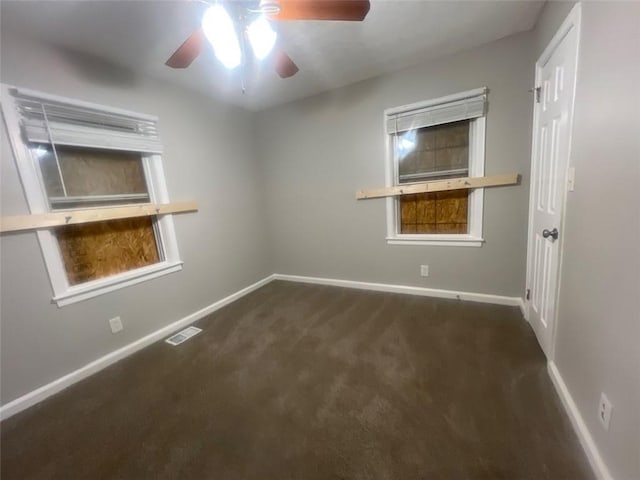 carpeted spare room featuring ceiling fan