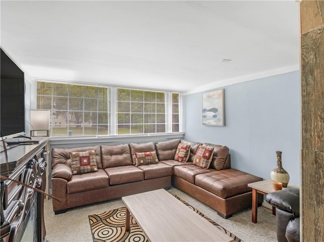 living area featuring light carpet