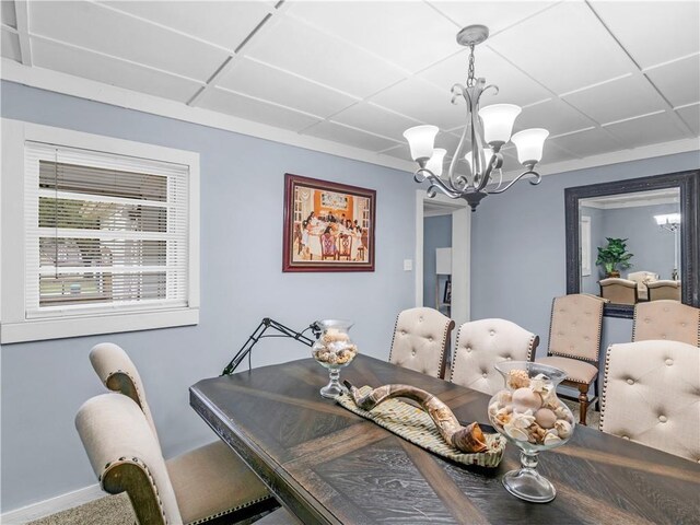 dining room featuring an inviting chandelier and baseboards