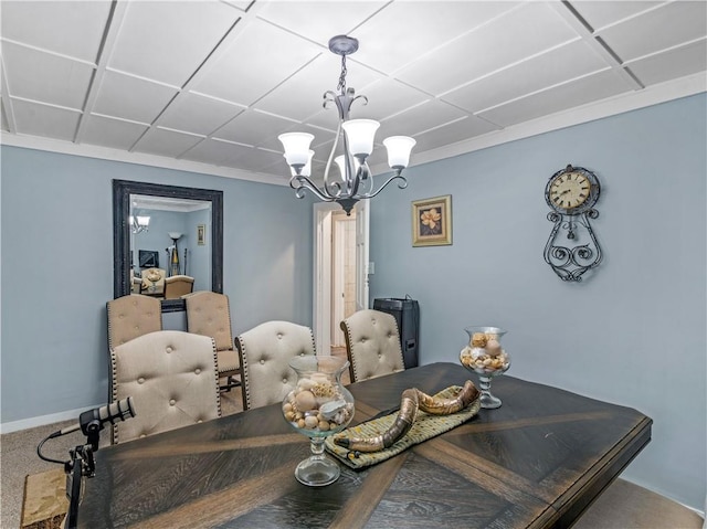 carpeted dining room featuring baseboards and an inviting chandelier