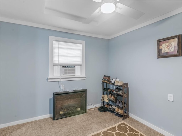 interior space with ceiling fan, baseboards, cooling unit, and light colored carpet