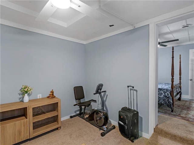 workout room featuring light carpet and baseboards