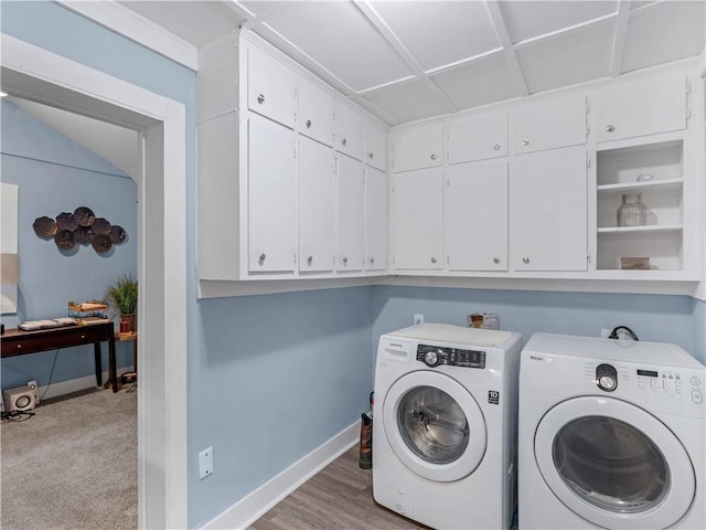 laundry room with separate washer and dryer, light colored carpet, cabinet space, and baseboards