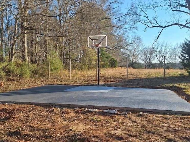 view of sport court featuring basketball hoop