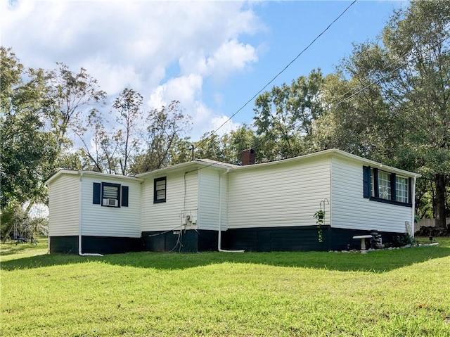 back of house with a lawn