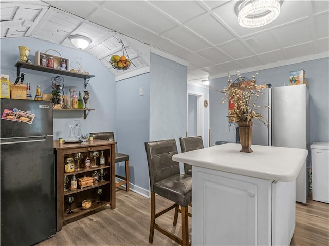 interior space featuring a paneled ceiling and wood finished floors