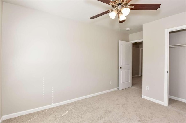 unfurnished bedroom featuring ceiling fan, a closet, and light carpet