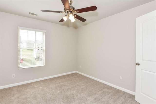 carpeted spare room featuring ceiling fan