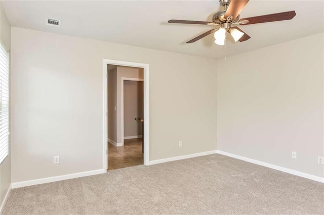 spare room with light carpet and ceiling fan