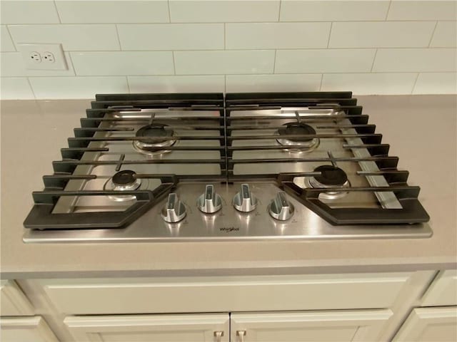 interior details featuring white cabinetry and stainless steel gas stovetop