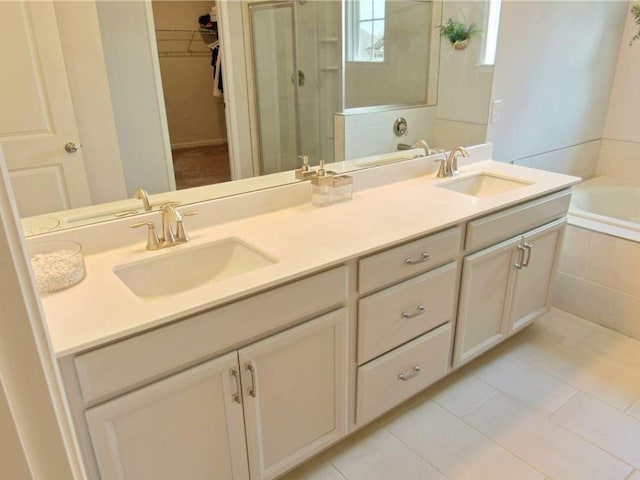 bathroom with plus walk in shower, vanity, and tile patterned flooring