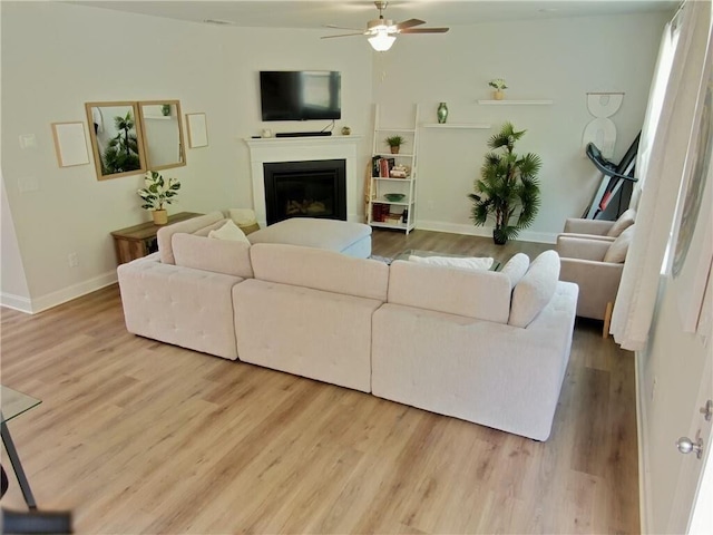 living room featuring hardwood / wood-style flooring and ceiling fan