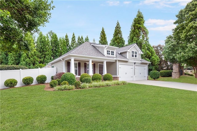 view of front of home featuring driveway, a garage, roof with shingles, fence, and a front lawn