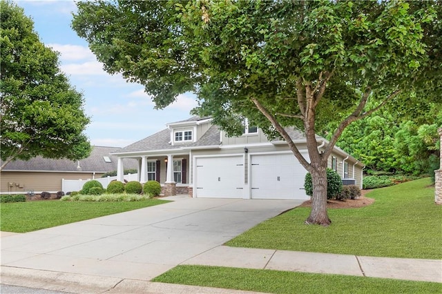 view of front of house featuring a garage, a front yard, concrete driveway, and board and batten siding