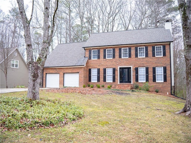 colonial-style house featuring a front lawn