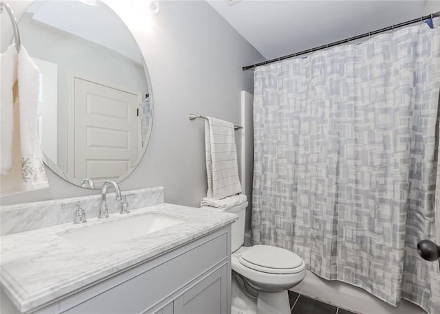 bathroom featuring tile patterned floors, vanity, and toilet