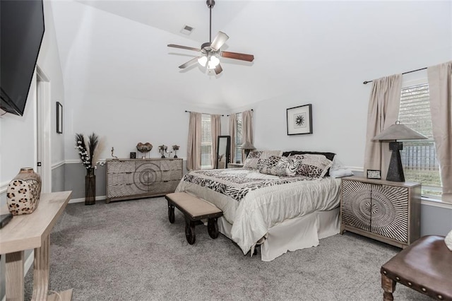 carpeted bedroom featuring high vaulted ceiling and ceiling fan