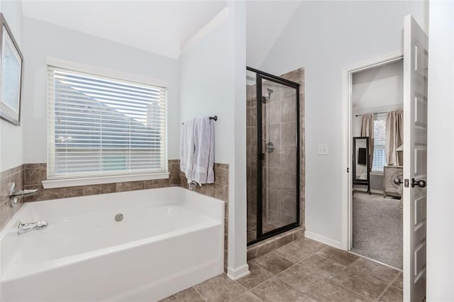 bathroom featuring separate shower and tub, tile patterned flooring, and lofted ceiling