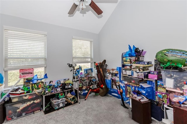 rec room with carpet flooring, ceiling fan, a healthy amount of sunlight, and lofted ceiling