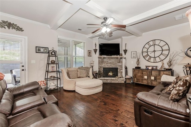 living room with dark hardwood / wood-style flooring, ceiling fan, crown molding, beam ceiling, and a stone fireplace