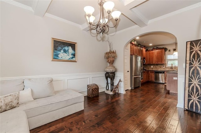 living room with a chandelier, dark hardwood / wood-style flooring, crown molding, and sink