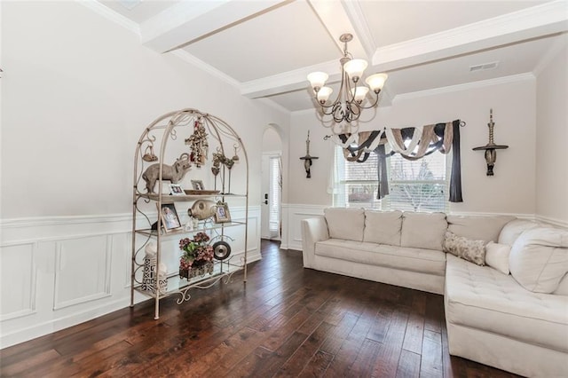 living room with ornamental molding, an inviting chandelier, dark wood-type flooring, and beam ceiling