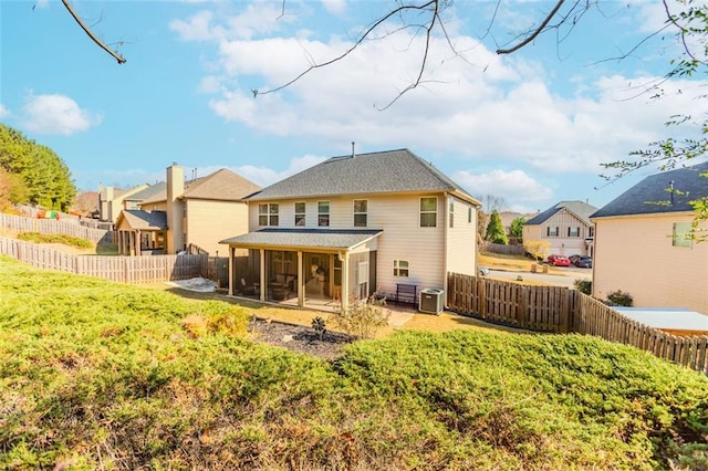 rear view of property with a sunroom, a patio area, and central air condition unit