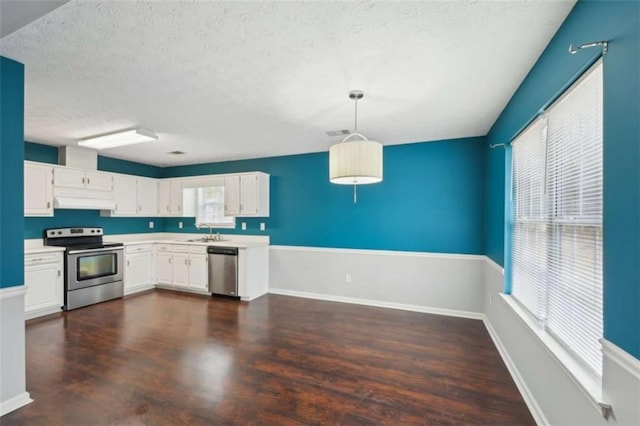 kitchen with a sink, stainless steel appliances, light countertops, and white cabinetry