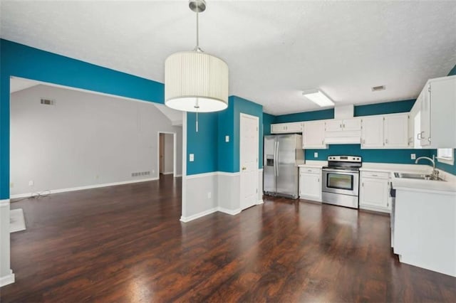 kitchen with a sink, light countertops, under cabinet range hood, appliances with stainless steel finishes, and open floor plan