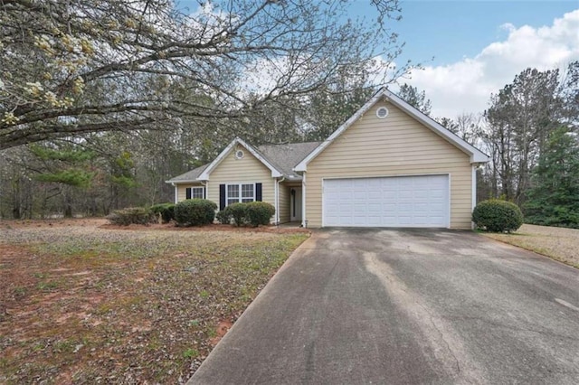 ranch-style home with a garage and concrete driveway