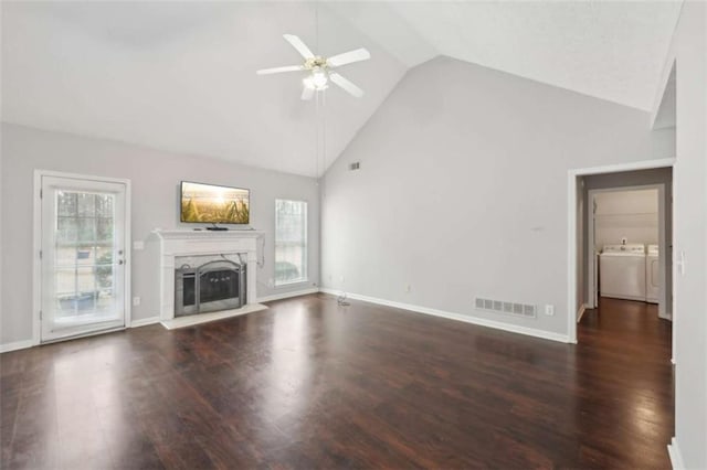 unfurnished living room with a ceiling fan, visible vents, wood finished floors, a fireplace, and independent washer and dryer